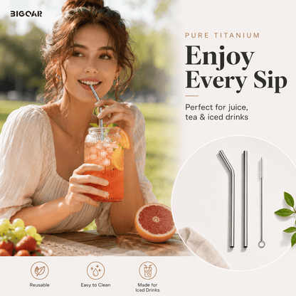 Young woman enjoying an iced fruit drink with a reusable pure titanium straw set outdoors